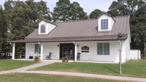 The White Hall city museum on Dollarway Road, a small white building with a brown metal roof.