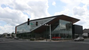 The Pine Bluff Main Library in Arkansas, a modern building with a sharply angled roofline and large glass panes.