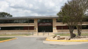 The Henry H. Chamberlin Forest Resources Complex at the University of Arkansas at Monticello, a two-story building with large windows and stone columns.